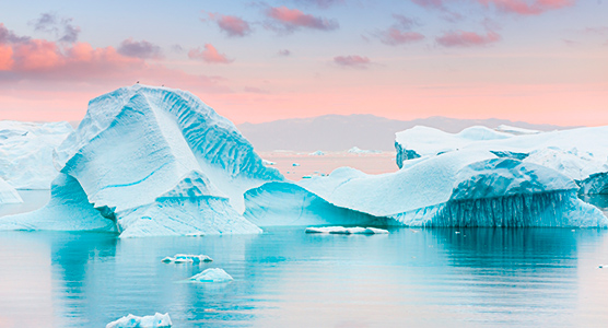 Gran iceberg azul flotando en las aguas de Groenlandia, uno de los paisajes más espectaculares del Ártico para un viaje de lujo.